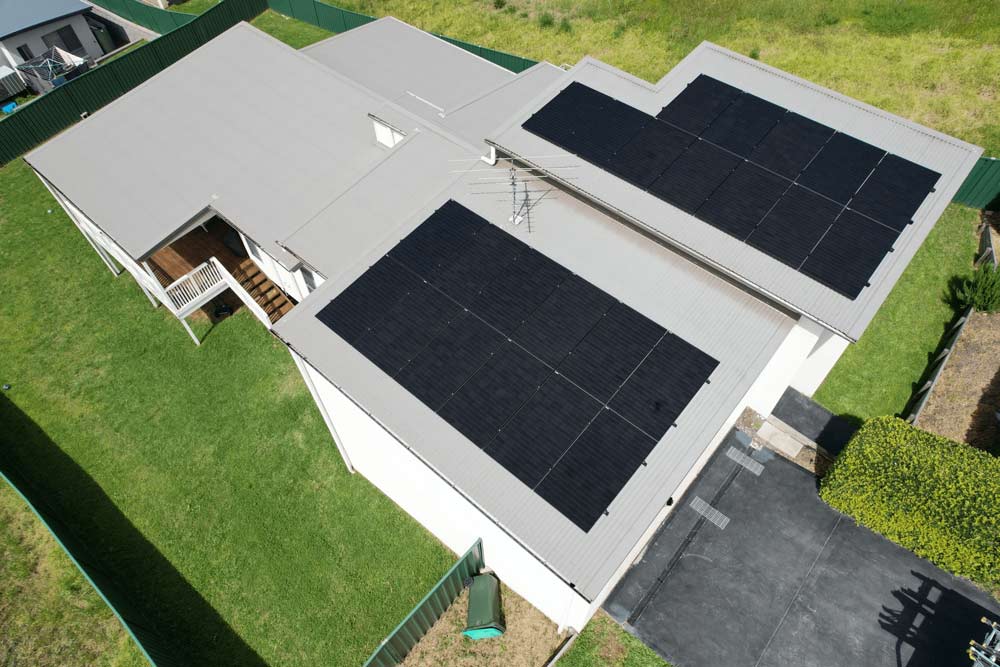 A house with solar panels on the roof by Hunter Valley