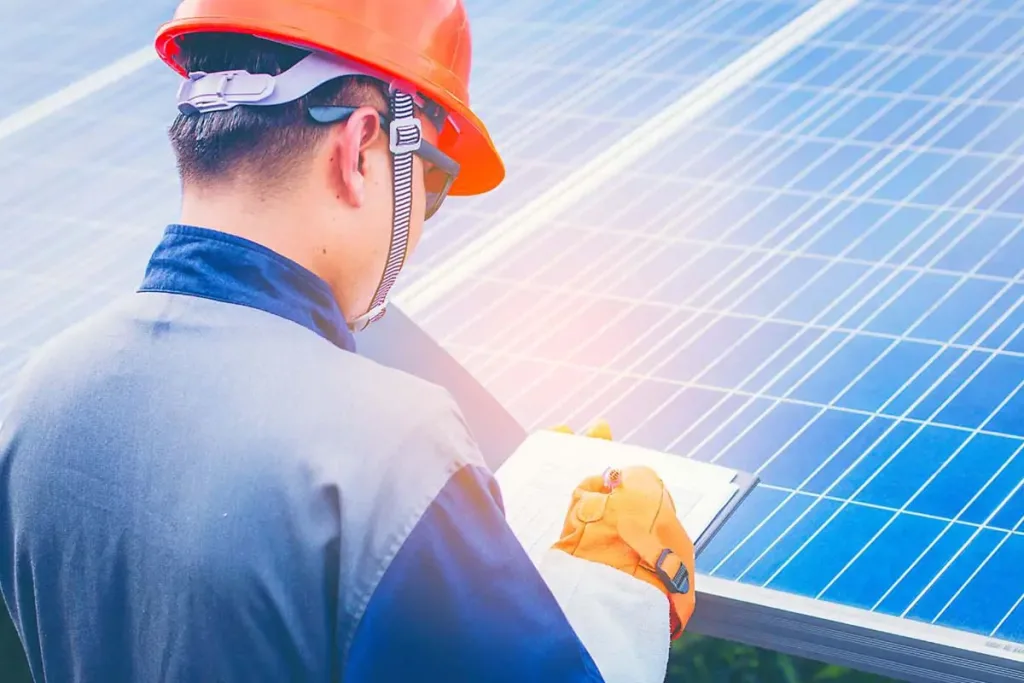 Technician inspecting solar panels.